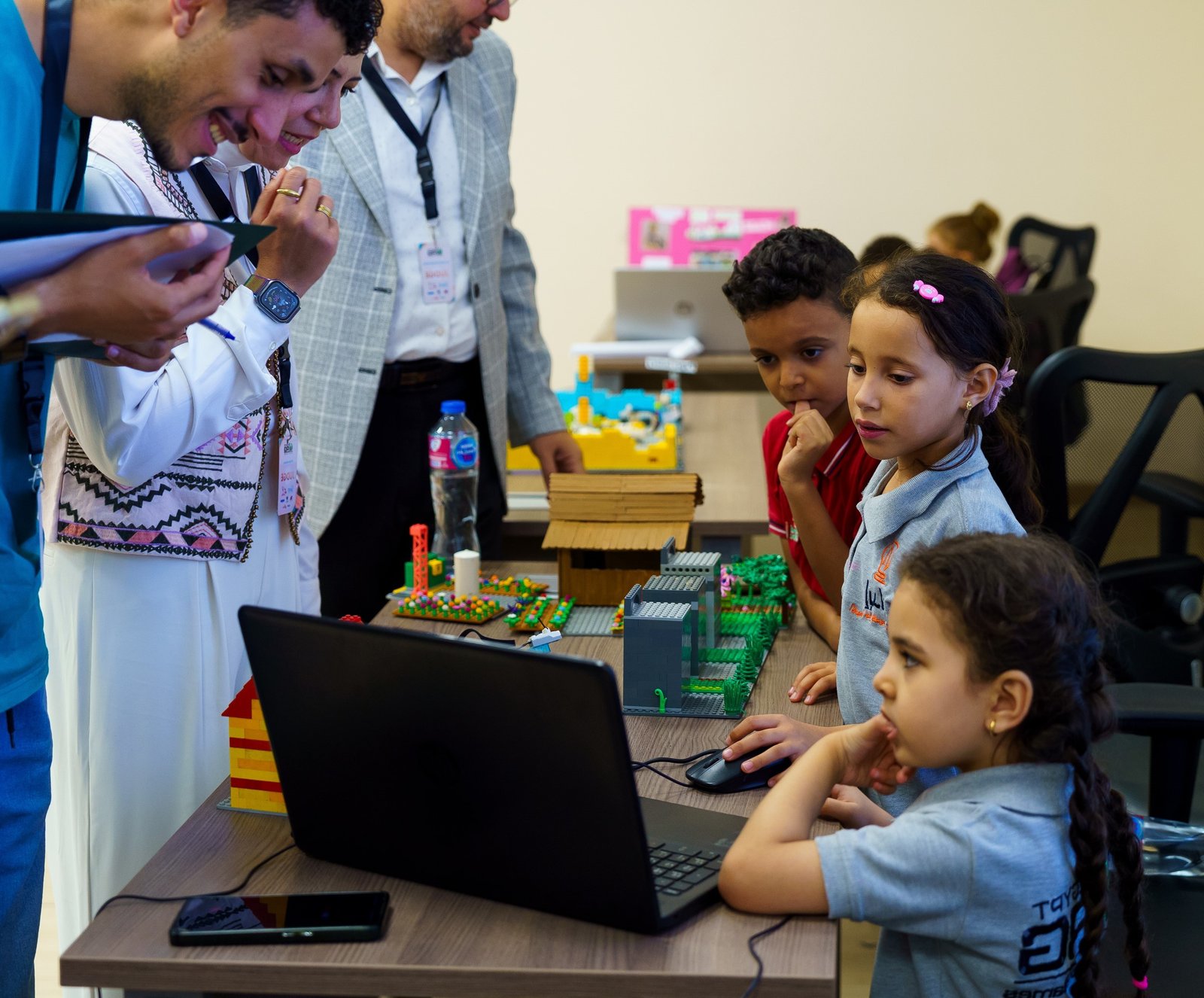 Ibdaa Academy students demonstrating their robotics project to judges at WRG